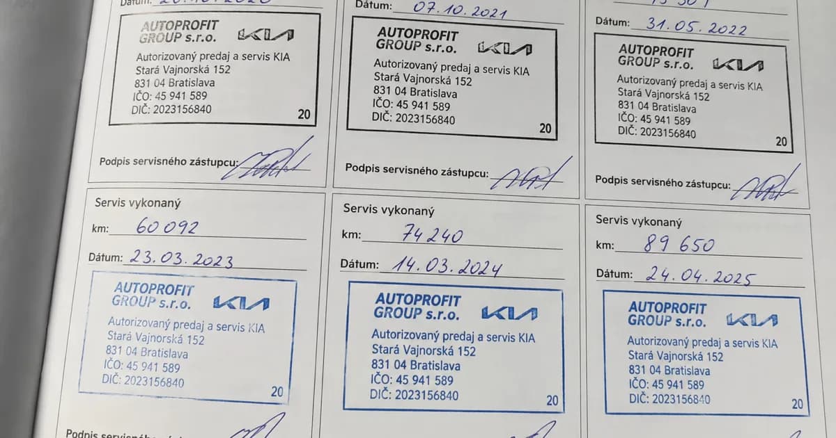 Close-up of a car service book with maintenance stamps and mileage records